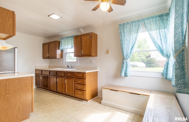 1520 W Losey St, Galesburg, IL 61401 - kitchen featuring brown cabinets, ceiling fan, light countertops, ornamental molding, and a sink