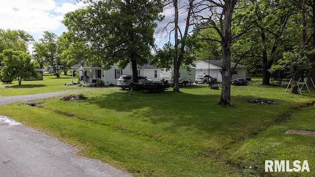 607 E 3rd St, Kinmundy, IL 62854 - view of front of property with a front yard and driveway