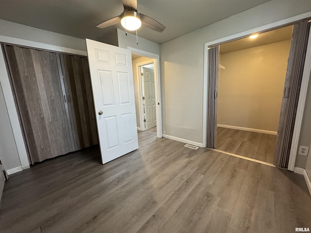 1248 N Ledlie Ave, Springfield, IL 62702 - unfurnished bedroom featuring a closet, wood finished floors, baseboards, and a ceiling fan