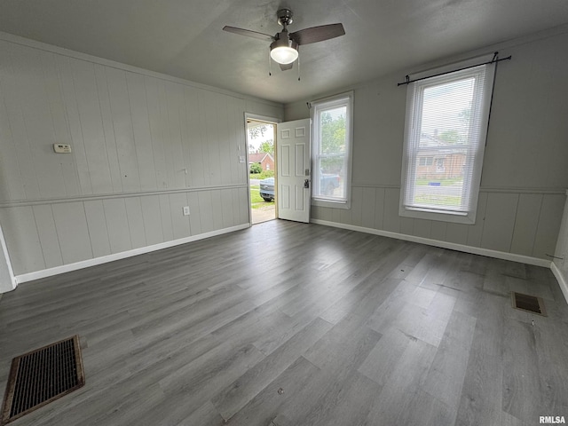 1248 N Ledlie Ave, Springfield, IL 62702 - empty room featuring wood finished floors, ceiling fan, a decorative wall, and baseboards