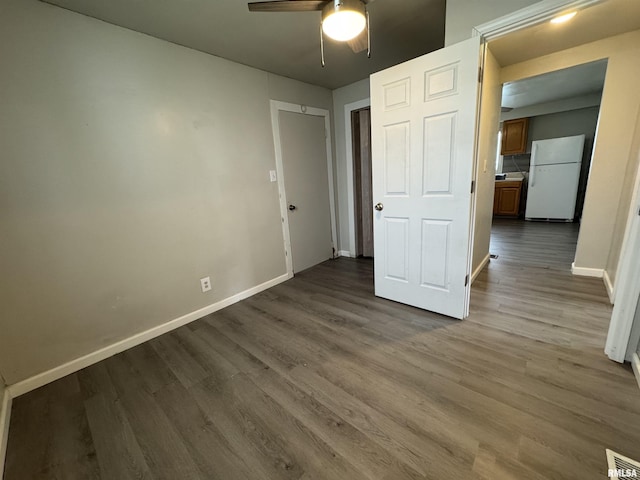 1248 N Ledlie Ave, Springfield, IL 62702 - unfurnished bedroom with freestanding refrigerator, wood finished floors, baseboards, and ceiling fan