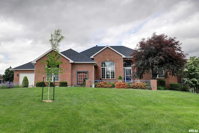 4511 Caleb Ln, Quincy, IL 62305 - view of front facade featuring brick siding, a front lawn, an attached garage, and roof with shingles