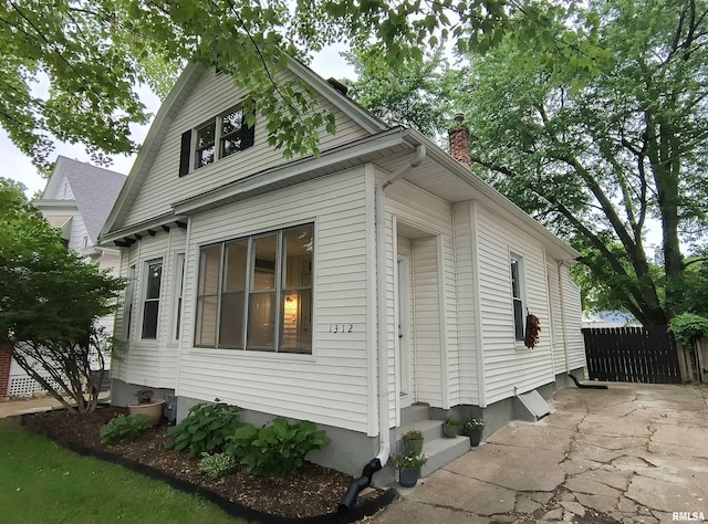 1312 N 3rd St, Springfield, IL 62702 - view of home's exterior featuring entry steps and a chimney