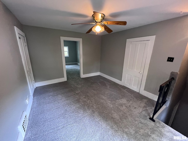 1312 N 3rd St, Springfield, IL 62702 - unfurnished bedroom with dark carpet, baseboards, a closet, and a ceiling fan