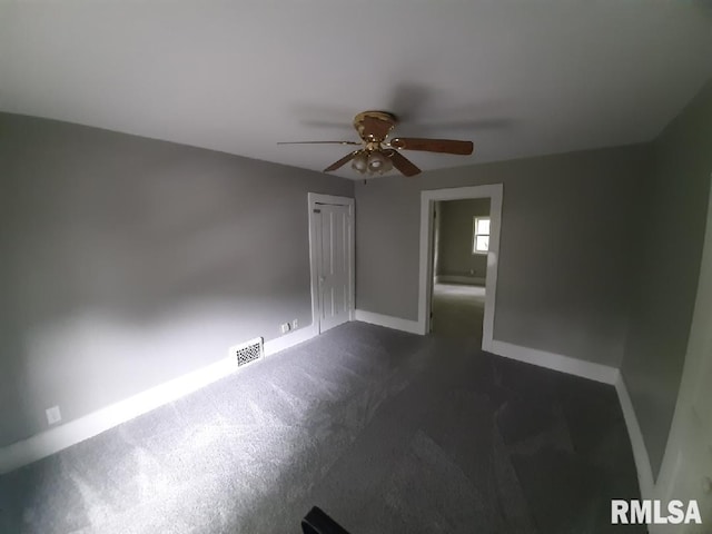 1312 N 3rd St, Springfield, IL 62702 - spare room featuring a ceiling fan, baseboards, and dark carpet