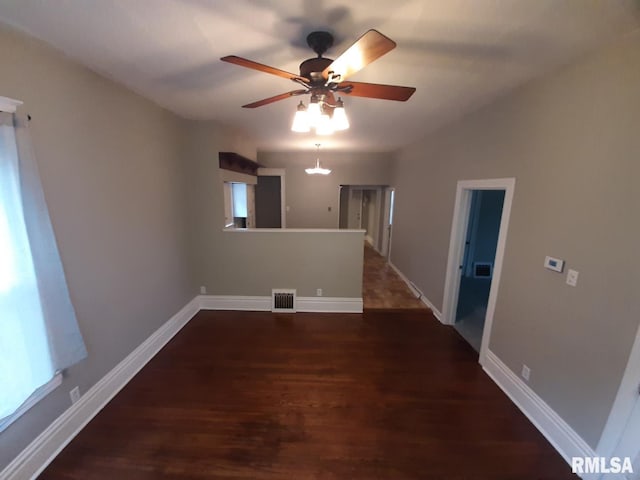 1312 N 3rd St, Springfield, IL 62702 - spare room with dark wood finished floors, ceiling fan, and baseboards