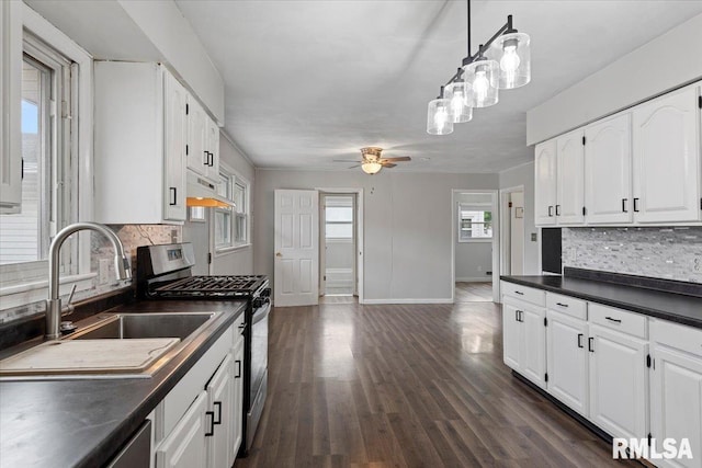 8 Melody Ln, Springfield, IL 62702 - kitchen with stainless steel appliances, dark countertops, a sink, under cabinet range hood, and tasteful backsplash