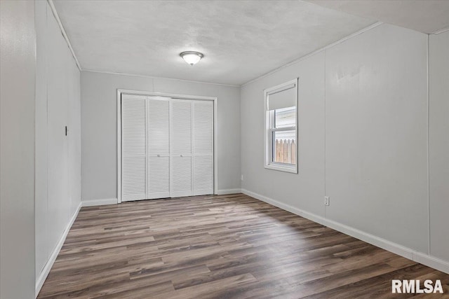 8 Melody Ln, Springfield, IL 62702 - unfurnished bedroom featuring wood finished floors, a closet, baseboards, and ornamental molding