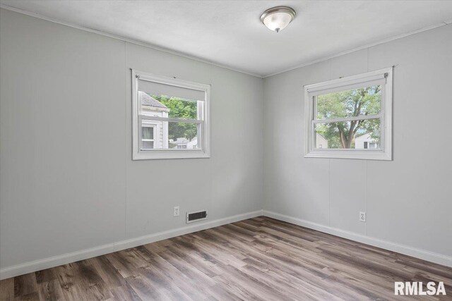 8 Melody Ln, Springfield, IL 62702 - spare room featuring wood finished floors, baseboards, and crown molding