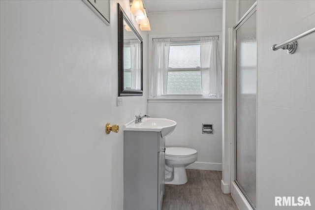 8 Melody Ln, Springfield, IL 62702 - bathroom featuring vanity, a stall shower, wood finished floors, toilet, and baseboards