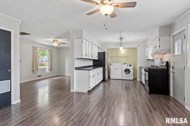 8 Melody Ln, Springfield, IL 62702 - kitchen featuring appliances with stainless steel finishes, washer and dryer, a ceiling fan, dark countertops, and white cabinets