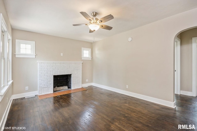 2428 S 8th St, Springfield, IL 62703 - unfurnished living room with ceiling fan, healthy amount of natural light, a fireplace, and arched walkways