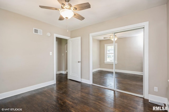 2428 S 8th St, Springfield, IL 62703 - unfurnished bedroom featuring wood finished floors, a closet, baseboards, and a ceiling fan