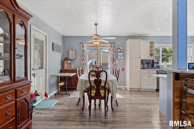 4101 N 8th St, Springfield, IL 62707 - dining room with a textured ceiling, light wood finished floors, a ceiling fan, and baseboards