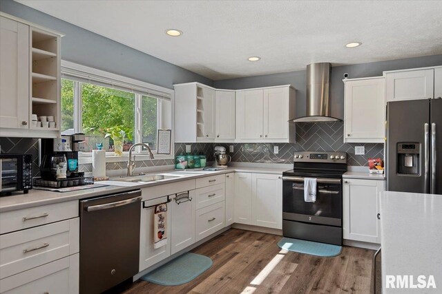 4101 N 8th St, Springfield, IL 62707 - kitchen featuring stainless steel appliances, open shelves, wall chimney range hood, a sink, and light countertops