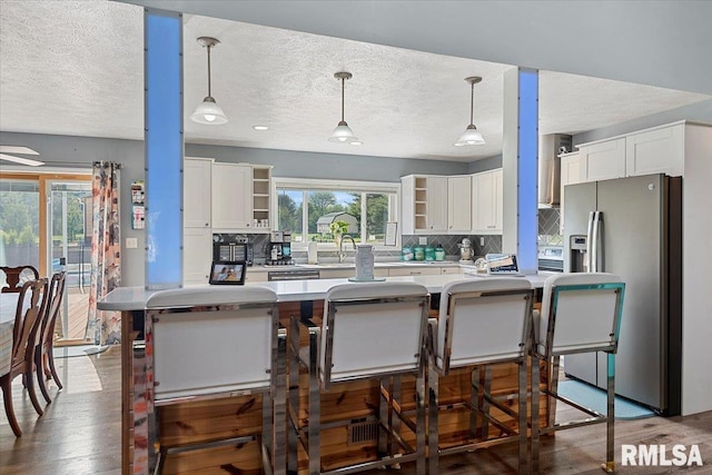 4101 N 8th St, Springfield, IL 62707 - kitchen featuring stainless steel fridge with ice dispenser, open shelves, white cabinets, tasteful backsplash, and light countertops