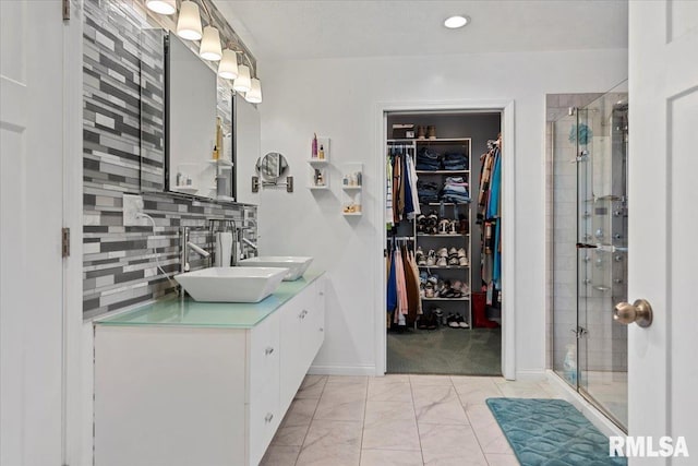 4101 N 8th St, Springfield, IL 62707 - full bathroom with a spacious closet, a shower stall, vanity, backsplash, and marble finish flooring
