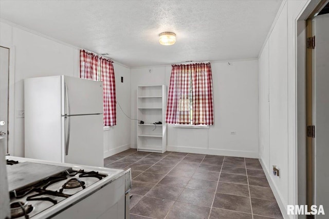 4101 N 8th St, Springfield, IL 62707 - kitchen featuring freestanding refrigerator, a textured ceiling, and baseboards