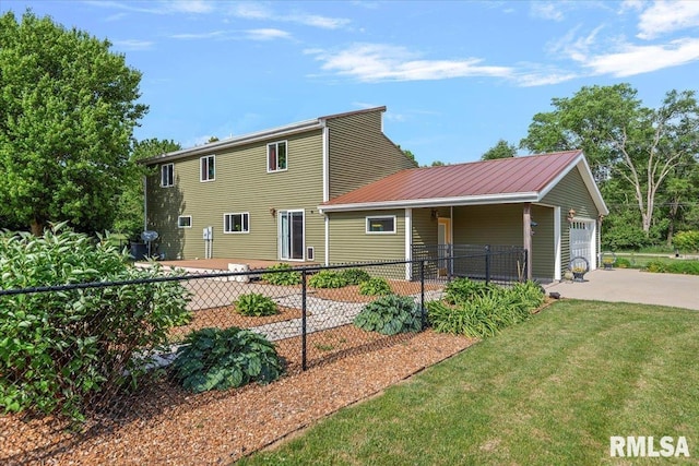 4101 N 8th St, Springfield, IL 62707 - back of house with a garage, concrete driveway, and metal roof