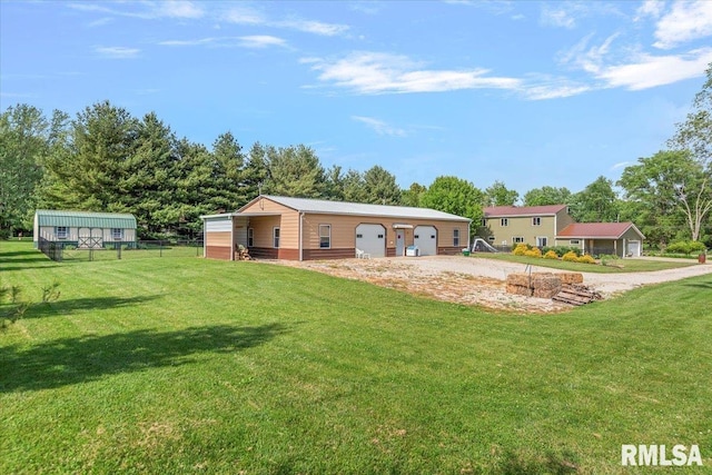 4101 N 8th St, Springfield, IL 62707 - rear view of property with a detached garage, an outdoor structure, and view of wooded area
