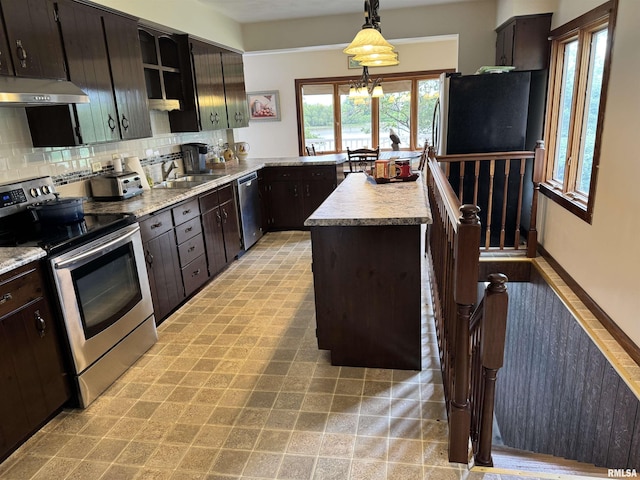 18382 N Quiver Beach Rd, Havana, IL 62644 - kitchen featuring stainless steel appliances, under cabinet range hood, a sink, light countertops, and tasteful backsplash