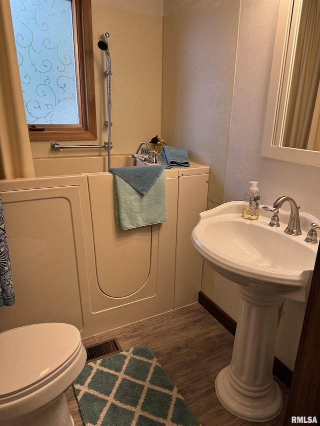 18382 N Quiver Beach Rd, Havana, IL 62644 - bathroom with wood finished floors and toilet