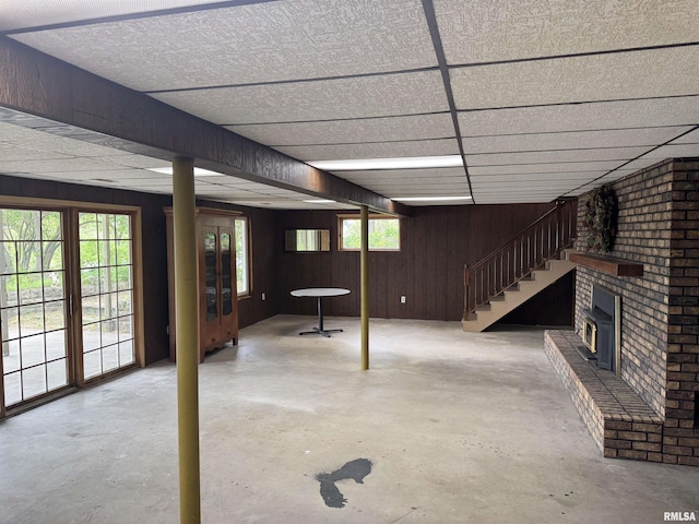 18382 N Quiver Beach Rd, Havana, IL 62644 - below grade area with wood walls, a brick fireplace, and stairs