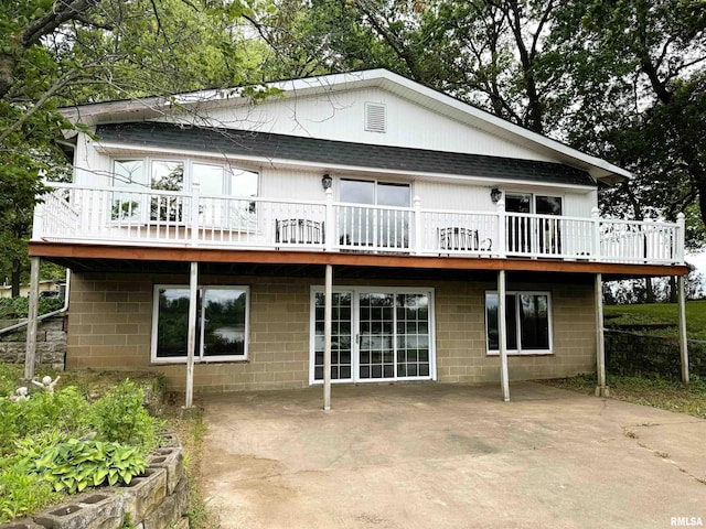 18382 N Quiver Beach Rd, Havana, IL 62644 - back of property featuring a shingled roof, a patio area, and a deck