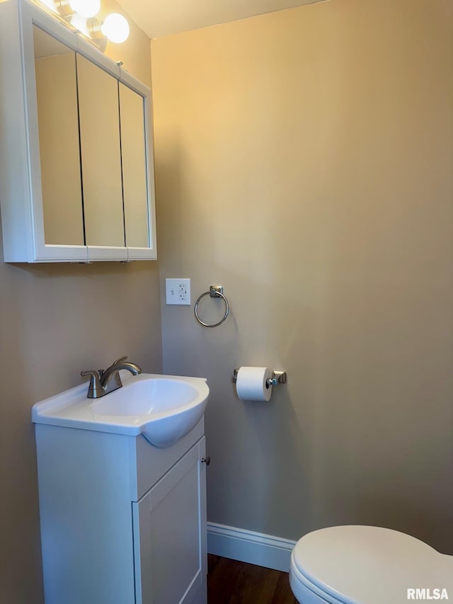 1106 S 19th St, Quincy, IL 62301 - bathroom featuring vanity, toilet, baseboards, and wood finished floors