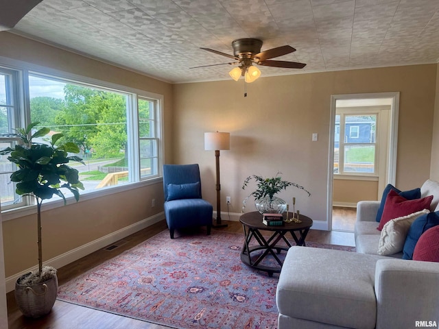1106 S 19th St, Quincy, IL 62301 - living area featuring wood finished floors, baseboards, and ceiling fan