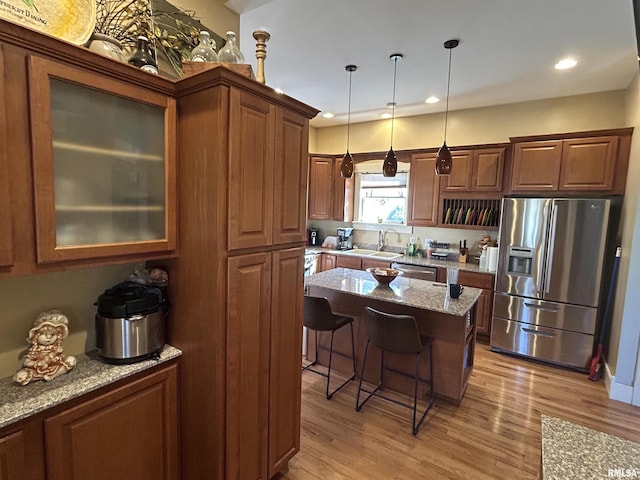 118 W Clark St, Havana, IL 62644 - kitchen with appliances with stainless steel finishes, a sink, a breakfast bar, light stone counters, and recessed lighting