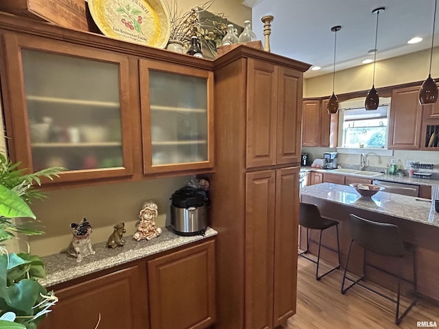 118 W Clark St, Havana, IL 62644 - kitchen featuring a sink, light stone counters, decorative light fixtures, glass insert cabinets, and recessed lighting
