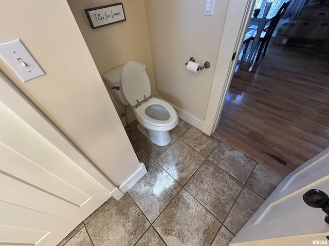 118 W Clark St, Havana, IL 62644 - bathroom featuring baseboards, toilet, and tile patterned flooring