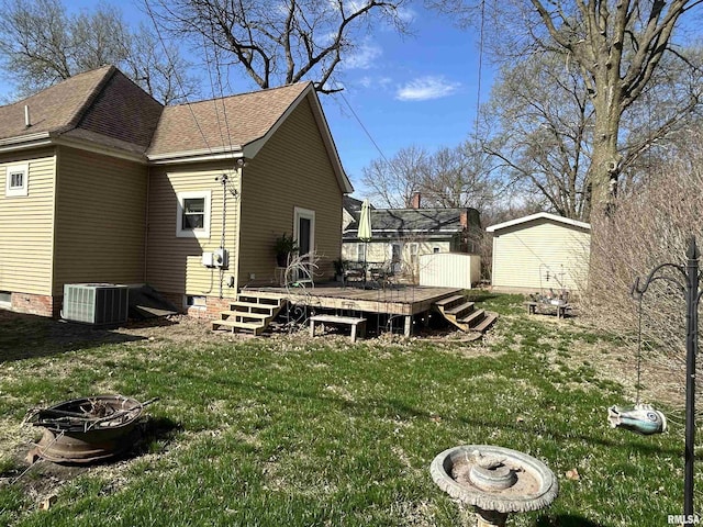 118 W Clark St, Havana, IL 62644 - rear view of house featuring central AC, an outdoor fire pit, a deck, a yard, and roof with shingles