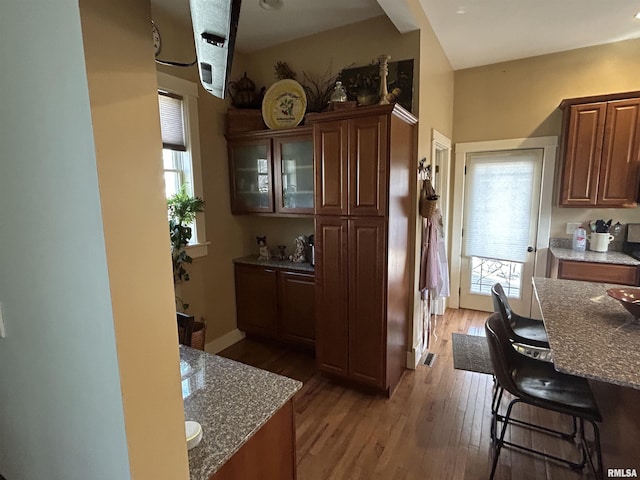 118 W Clark St, Havana, IL 62644 - kitchen featuring light wood-type flooring, stone countertops, and healthy amount of natural light