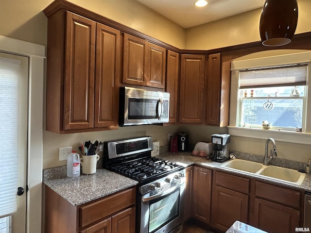 118 W Clark St, Havana, IL 62644 - kitchen featuring stainless steel appliances, a sink, and brown cabinetry