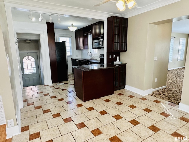 1595 N Kellogg St, Galesburg, IL 61401 - kitchen featuring stainless steel microwave, freestanding refrigerator, ceiling fan, glass insert cabinets, and a peninsula