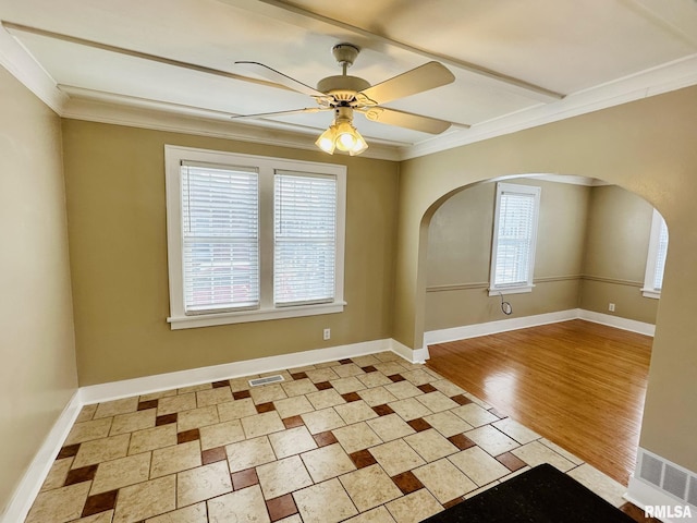 1595 N Kellogg St, Galesburg, IL 61401 - empty room featuring arched walkways, crown molding, a ceiling fan, and baseboards
