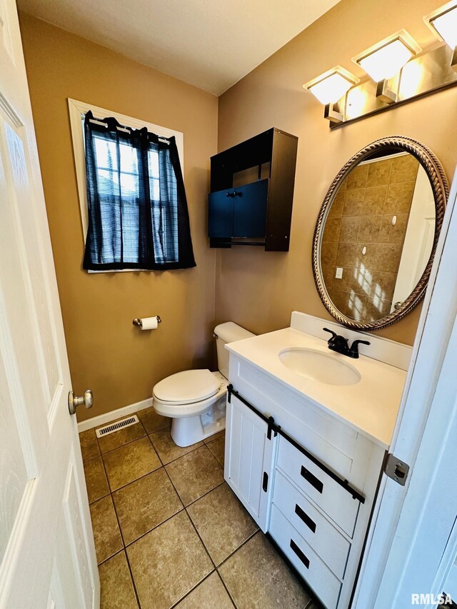 1595 N Kellogg St, Galesburg, IL 61401 - bathroom featuring toilet, vanity, tile patterned flooring, and baseboards