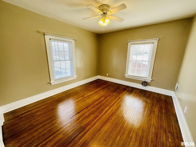 1595 N Kellogg St, Galesburg, IL 61401 - empty room with hardwood / wood-style floors, plenty of natural light, a ceiling fan, and baseboards