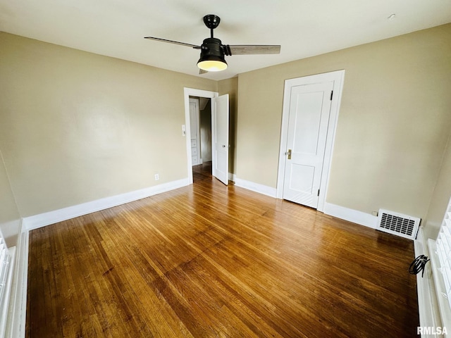 1595 N Kellogg St, Galesburg, IL 61401 - unfurnished room with wood finished floors, baseboards, and a ceiling fan