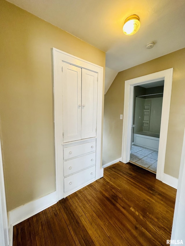 1595 N Kellogg St, Galesburg, IL 61401 - unfurnished bedroom featuring dark wood-type flooring, baseboards, and a closet