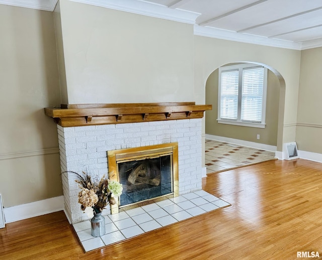 1595 N Kellogg St, Galesburg, IL 61401 - detailed view of wood finished floors, a fireplace, ornamental molding, baseboards, and arched walkways