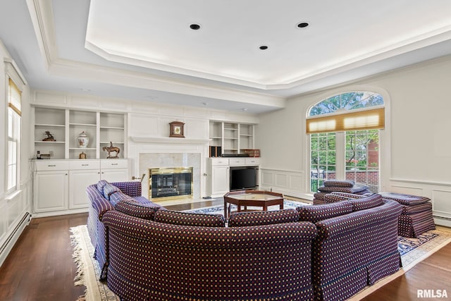 1044 Williams Blvd, Springfield, IL 62704 - living room featuring a raised ceiling, healthy amount of natural light, a decorative wall, a baseboard radiator, and dark wood-style floors