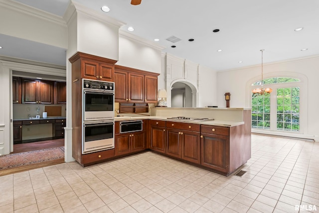 1044 Williams Blvd, Springfield, IL 62704 - kitchen with white double oven, a warming drawer, light countertops, crown molding, and a chandelier