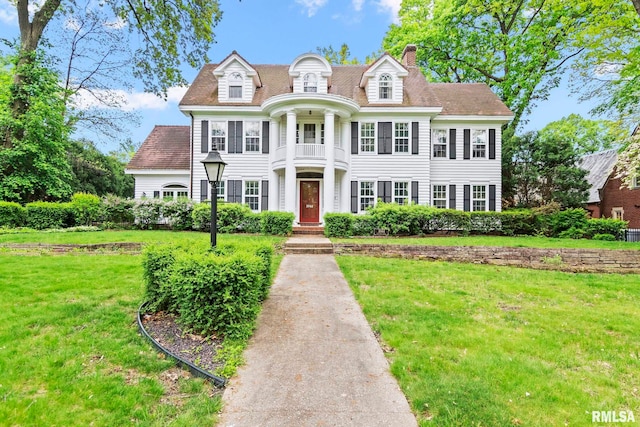 1044 Williams Blvd, Springfield, IL 62704 - view of front facade with a front yard, a balcony, and a chimney