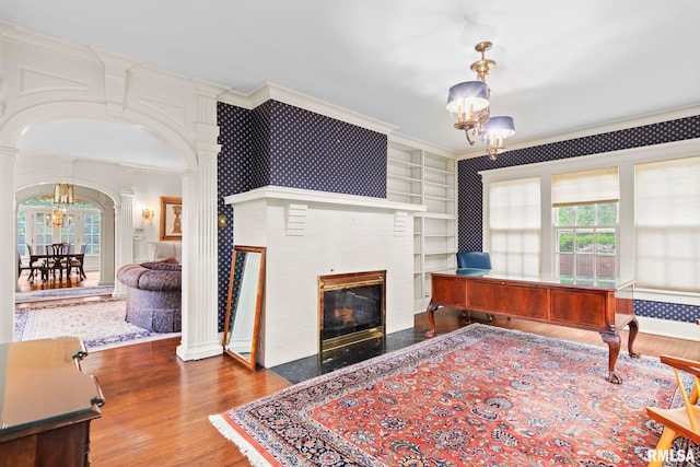 1044 Williams Blvd, Springfield, IL 62704 - living area featuring a chandelier, ornamental molding, wood finished floors, arched walkways, and healthy amount of natural light