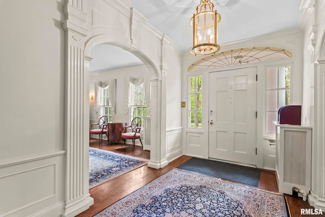 1044 Williams Blvd, Springfield, IL 62704 - entryway featuring arched walkways, dark wood finished floors, a chandelier, and ornamental molding