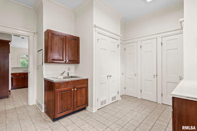1044 Williams Blvd, Springfield, IL 62704 - kitchen with a sink, light tile patterned floors, light countertops, and crown molding