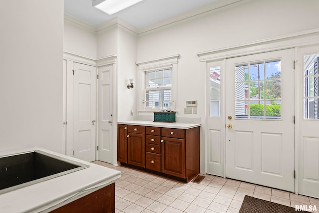 1044 Williams Blvd, Springfield, IL 62704 - kitchen with light tile patterned floors, light countertops, plenty of natural light, and crown molding